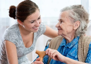 alzheimer's patient at memory care facility with caretaker